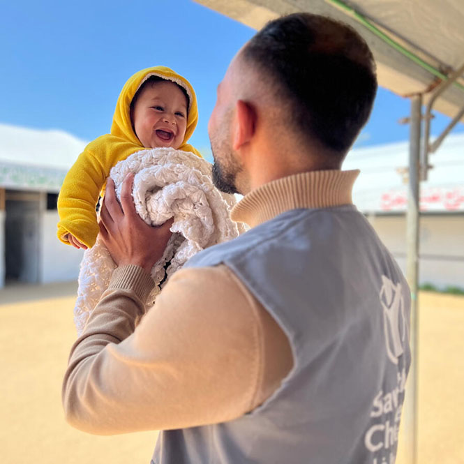 Sameer, 6 months old with Ali of the Save the Children Staff